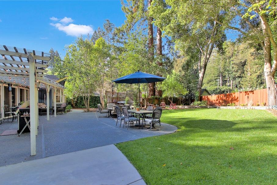 180 Locust Lane Ben Lomond, CA 95005 - Photo 2 of 33 a view of a table and chairs under an umbrella in the garden