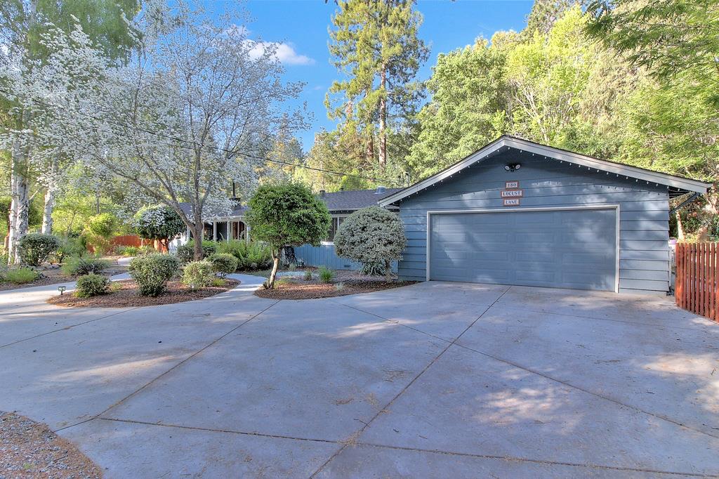 180 Locust Lane Ben Lomond, CA 95005 - Photo 22 of 33 a front view of a house with a yard and garage