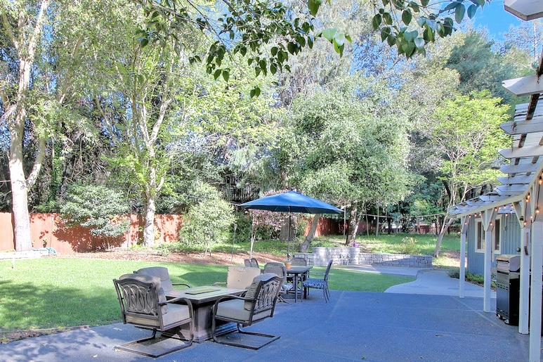 180 Locust Lane Ben Lomond, CA 95005 - Photo 27 of 33 a view of a table and chairs under an umbrella