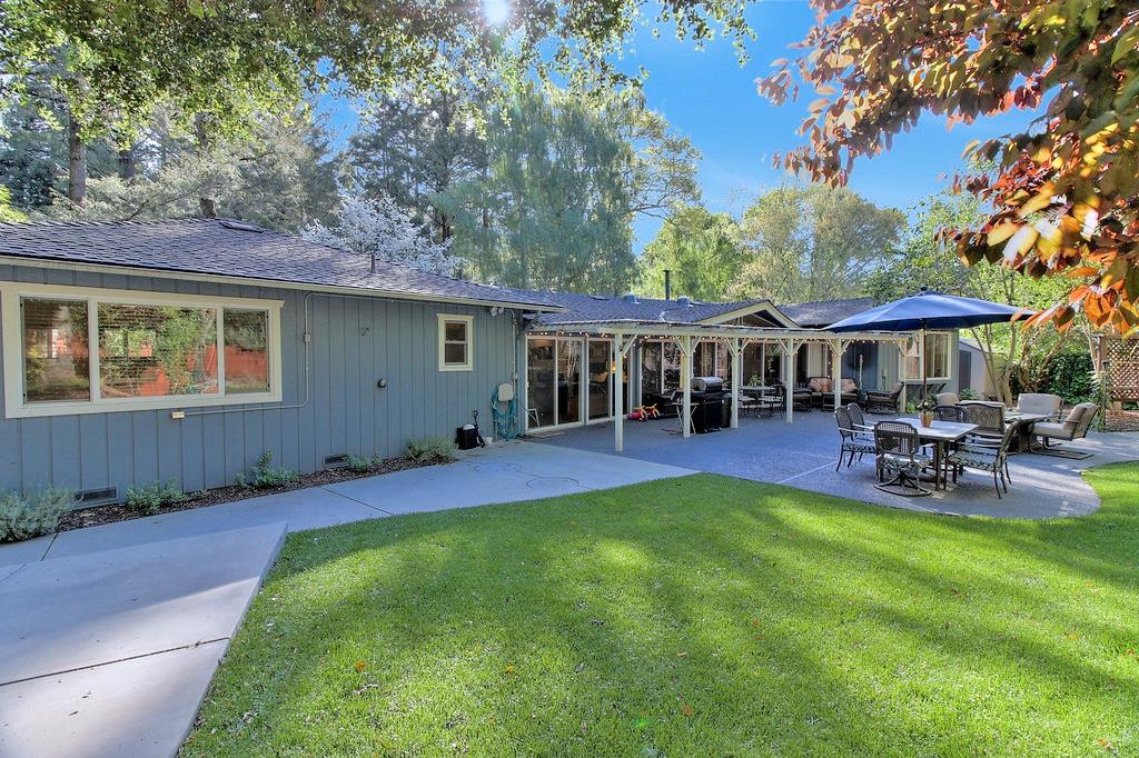 180 Locust Lane Ben Lomond, CA 95005 - Photo 28 of 33 a view of a house with table and chairs under an umbrella