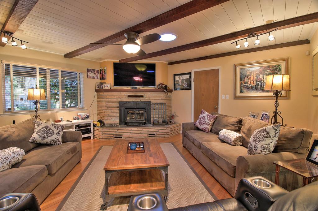 180 Locust Lane Ben Lomond, CA 95005 - Photo 9 of 33 a living room with furniture a flat screen tv and a fireplace