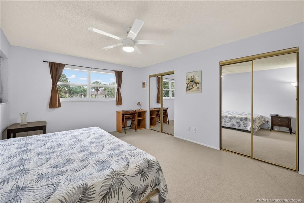 2950 Southeast Ocean Boulevard, Unit 1357 Stuart, FL 34996 - Photo 11 of 25 a bedroom with a bed and a chandelier
