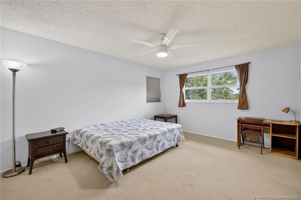2950 Southeast Ocean Boulevard, Unit 1357 Stuart, FL 34996 - Photo 12 of 25 a bedroom with a bed and a desk