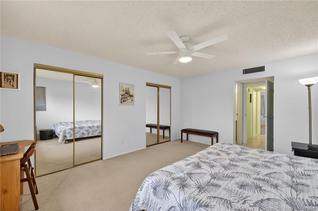 2950 Southeast Ocean Boulevard, Unit 1357 Stuart, FL 34996 - Photo 13 of 25 a bedroom with a bed and a large mirror