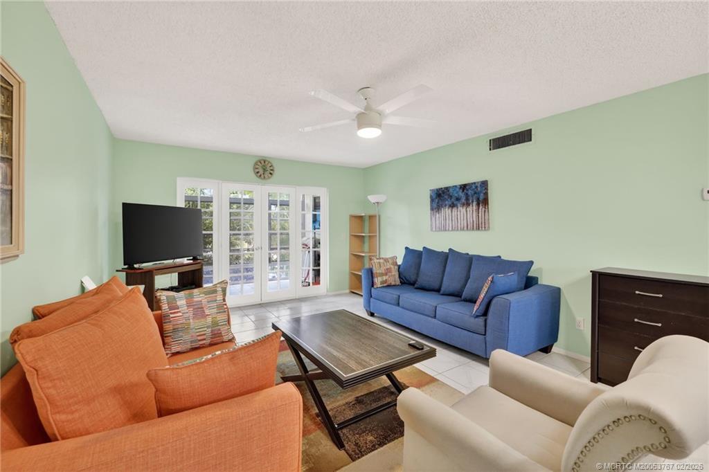 2950 Southeast Ocean Boulevard, Unit 1357 Stuart, FL 34996 - Photo 7 of 25 a living room with furniture and a flat screen tv