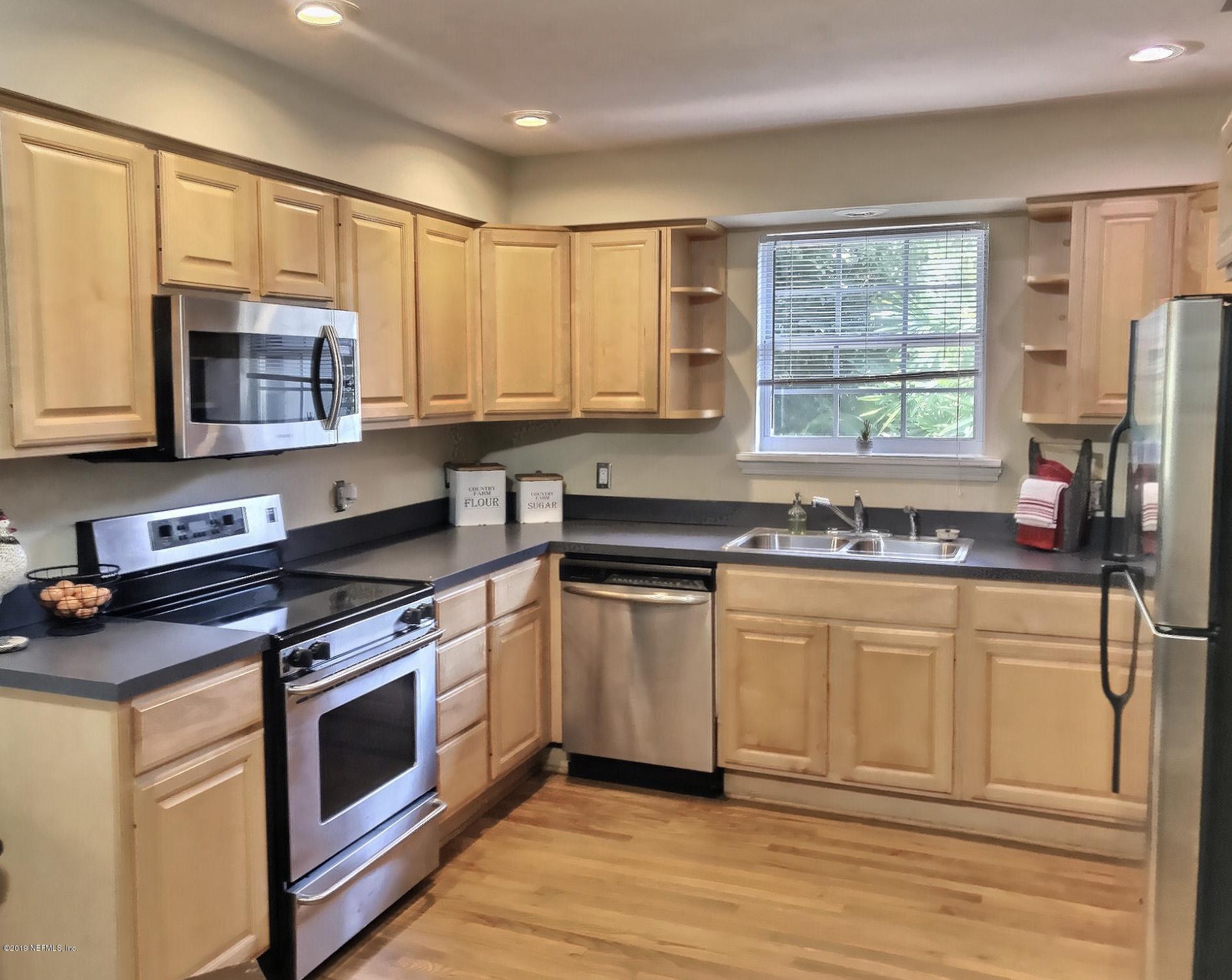 4631 Martingale Road Jacksonville, FL 32210 - Photo 12 of 27 a kitchen with stainless steel appliances granite countertop a stove a sink and a microwave