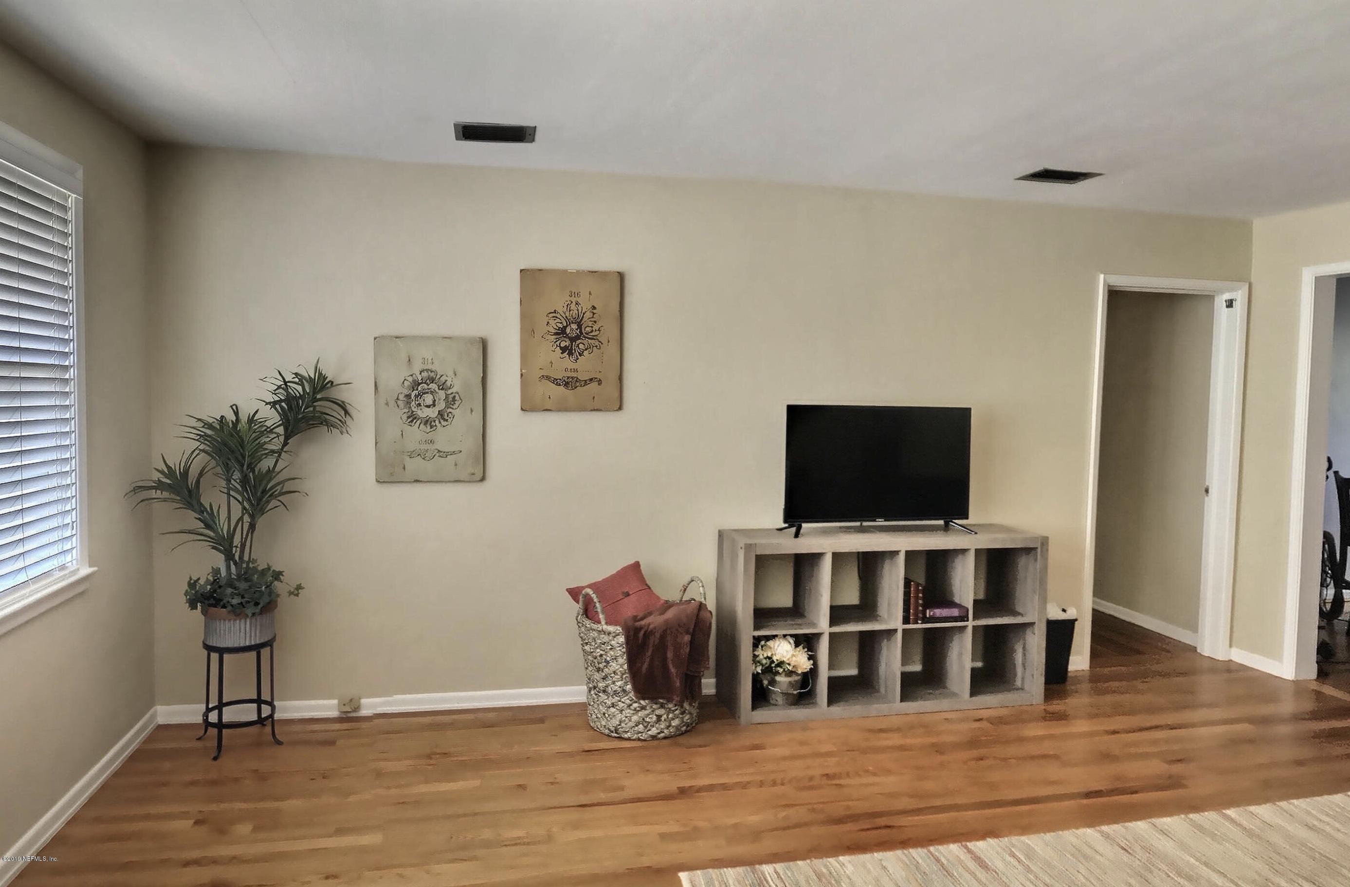 4631 Martingale Road Jacksonville, FL 32210 - Photo 13 of 27 a view of a livingroom with furniture and wooden floor