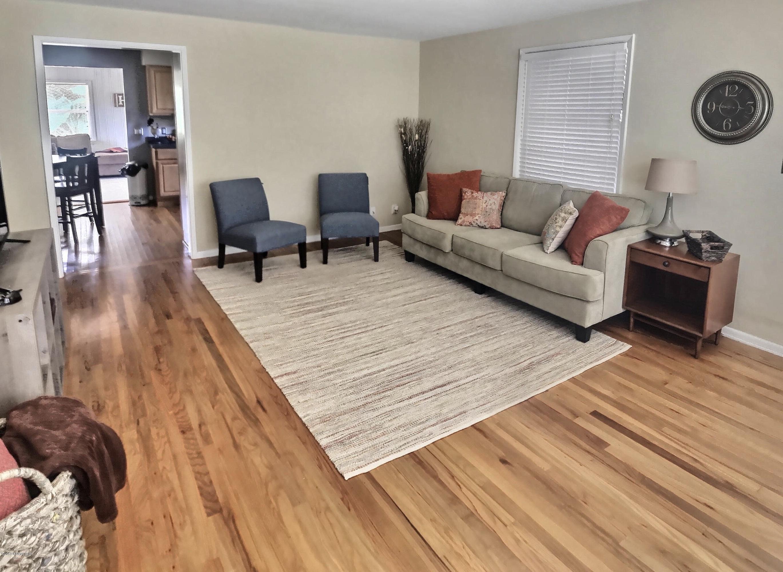 4631 Martingale Road Jacksonville, FL 32210 - Photo 14 of 27 a living room with furniture and a wooden floor