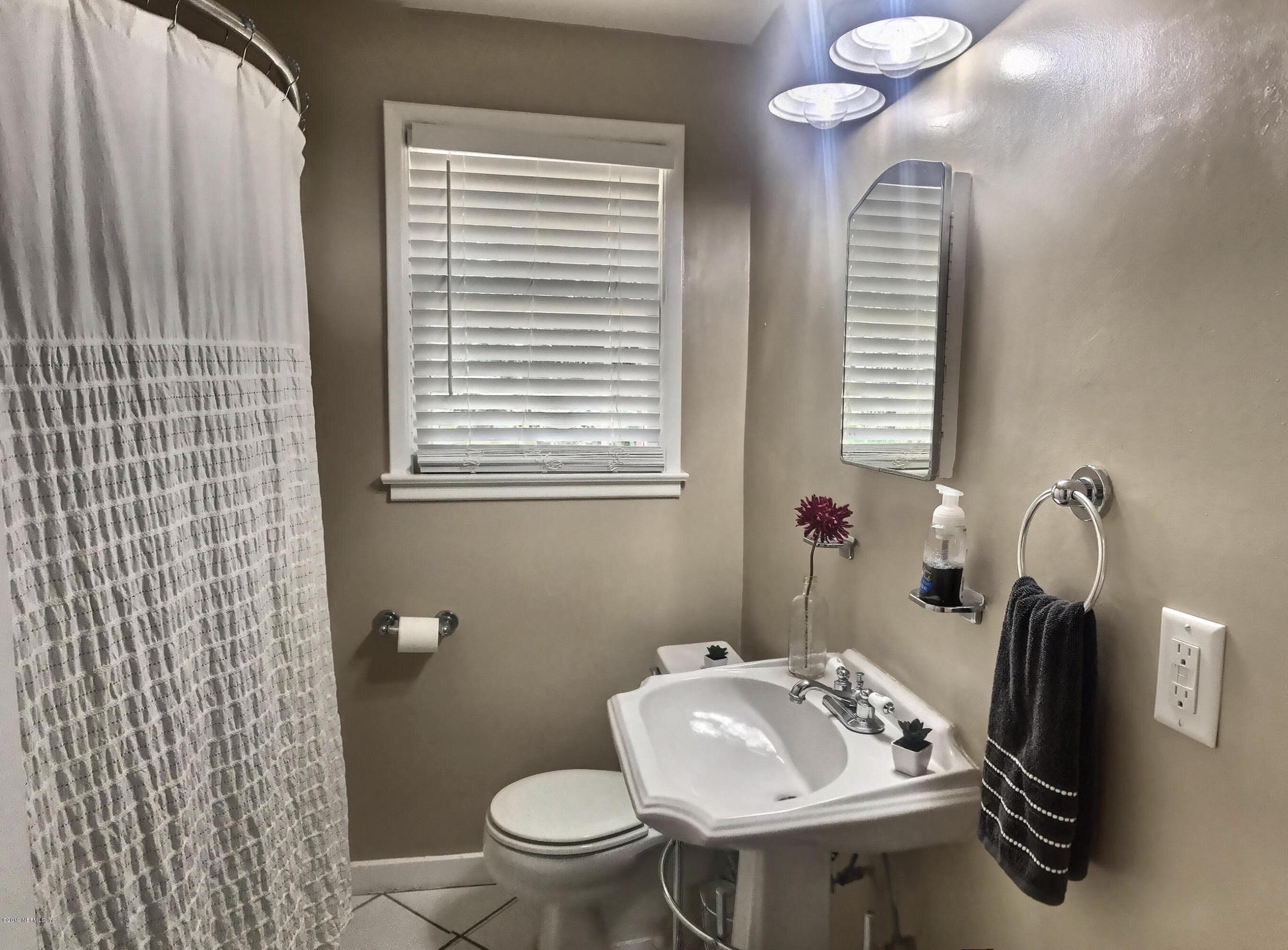 4631 Martingale Road Jacksonville, FL 32210 - Photo 16 of 27 a bathroom with a sink toilet and a mirror