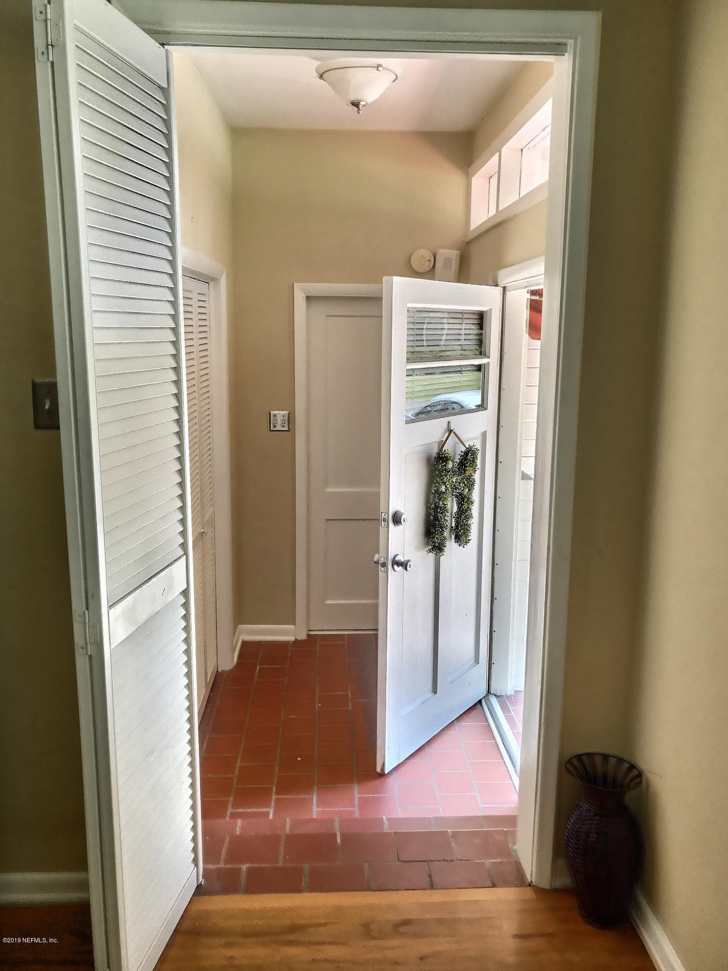 4631 Martingale Road Jacksonville, FL 32210 - Photo 2 of 27 a view of a hallway with wooden floor and entryway