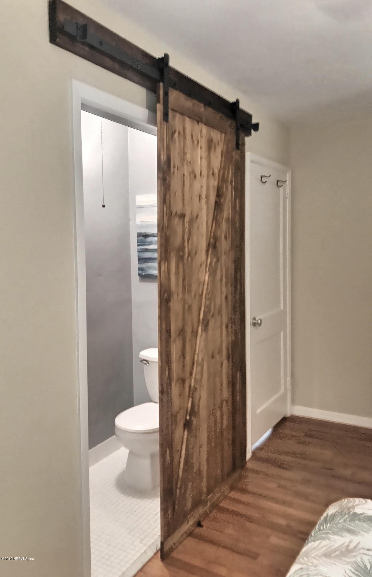 4631 Martingale Road Jacksonville, FL 32210 - Photo 22 of 27 a bathroom with a shower a toilet and a shower
