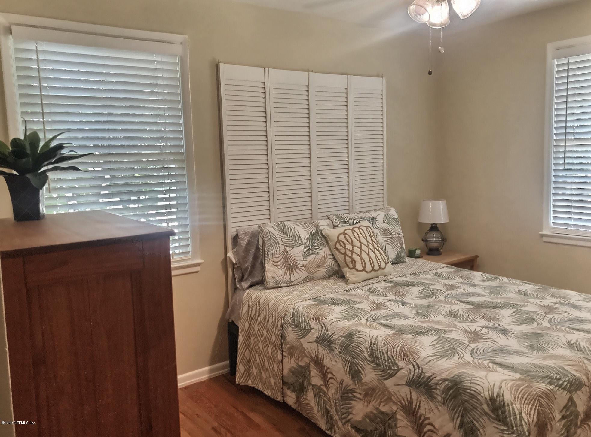 4631 Martingale Road Jacksonville, FL 32210 - Photo 25 of 27 a bedroom with a large bed and a potted plant