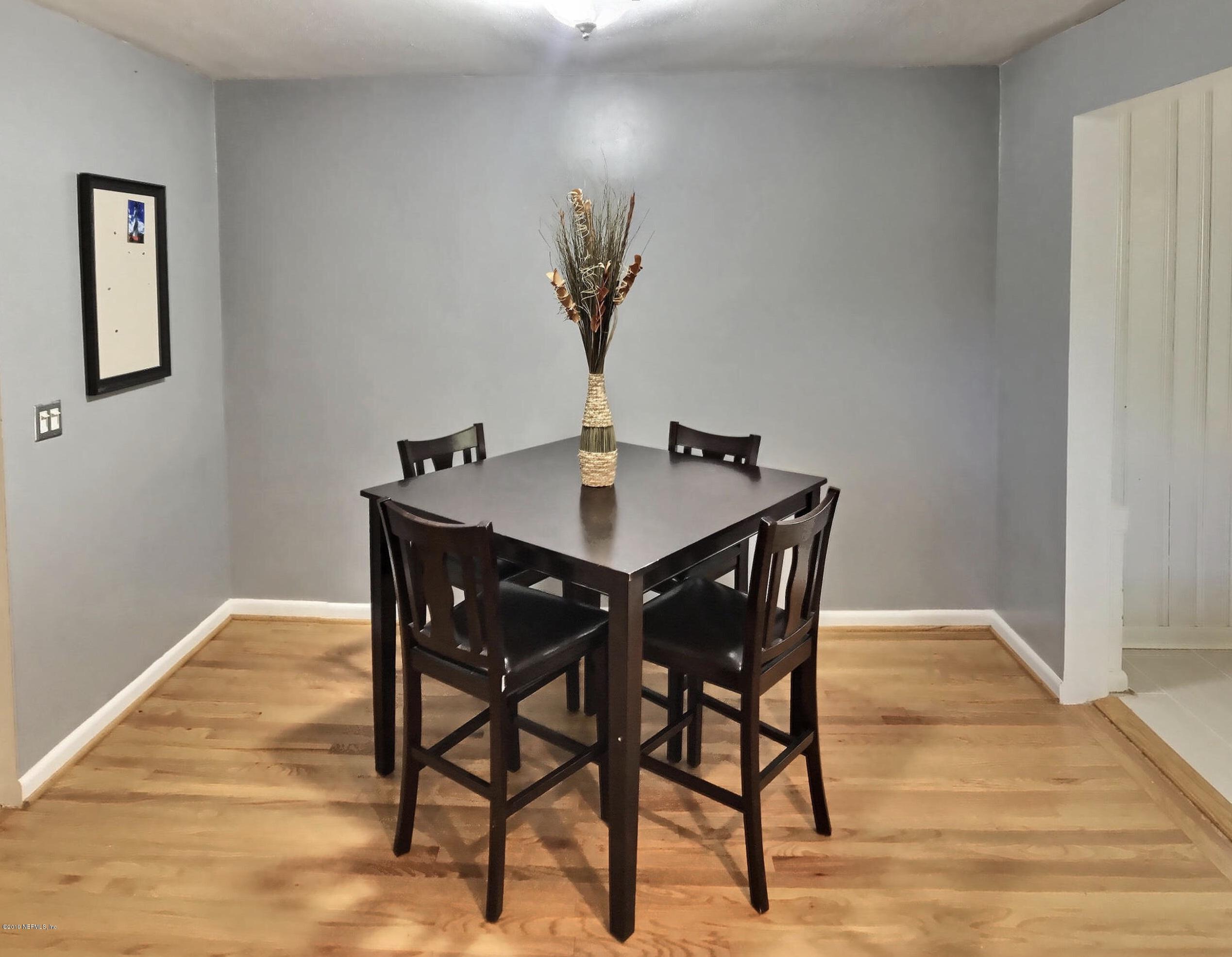 4631 Martingale Road Jacksonville, FL 32210 - Photo 10 of 27 a view of a dining room with a table and chairs