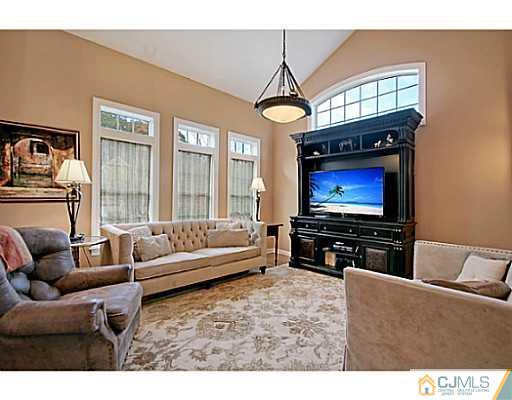 191 Smoke Rise Road Bernards, NJ 07920 - Photo 12 of 25 a living room with furniture a flat screen tv and a window