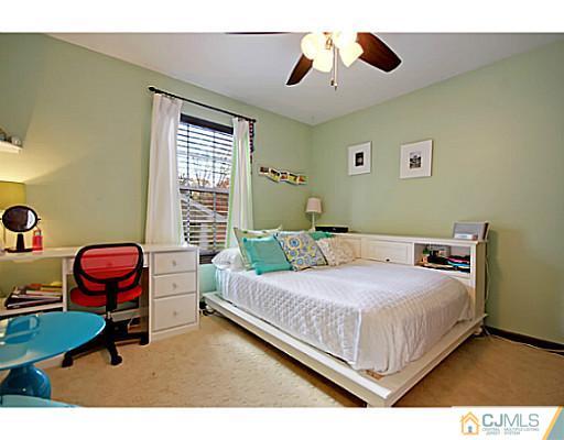 191 Smoke Rise Road Bernards, NJ 07920 - Photo 16 of 25 a bedroom with a bed a chair and a chandelier