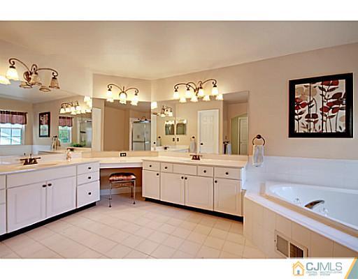 191 Smoke Rise Road Bernards, NJ 07920 - Photo 22 of 25 a spacious bathroom with a granite countertop sink mirror and bathtub