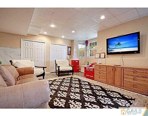 191 Smoke Rise Road Bernards, NJ 07920 - Photo 23 of 25 a living room with furniture and a flat screen tv