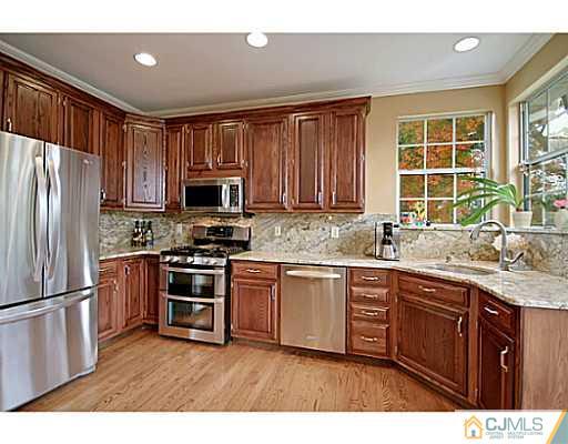 191 Smoke Rise Road Bernards, NJ 07920 - Photo 4 of 25 a kitchen with stainless steel appliances granite countertop a stove a sink dishwasher a refrigerator and a microwave oven with wooden floor