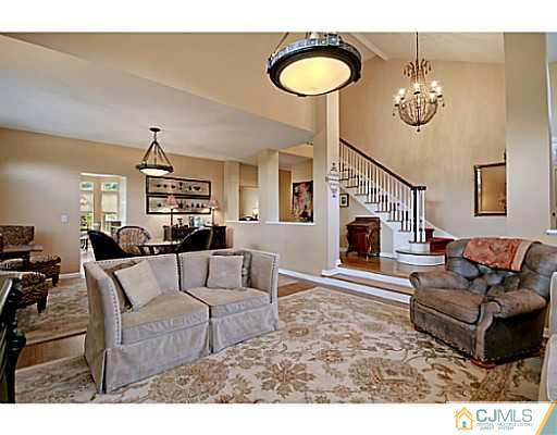 191 Smoke Rise Road Bernards, NJ 07920 - Photo 7 of 25 a living room with furniture a dining table and a fireplace