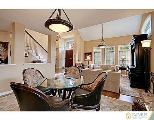 191 Smoke Rise Road Bernards, NJ 07920 - Photo 10 of 25 a dining room with furniture a chandelier and wooden floor