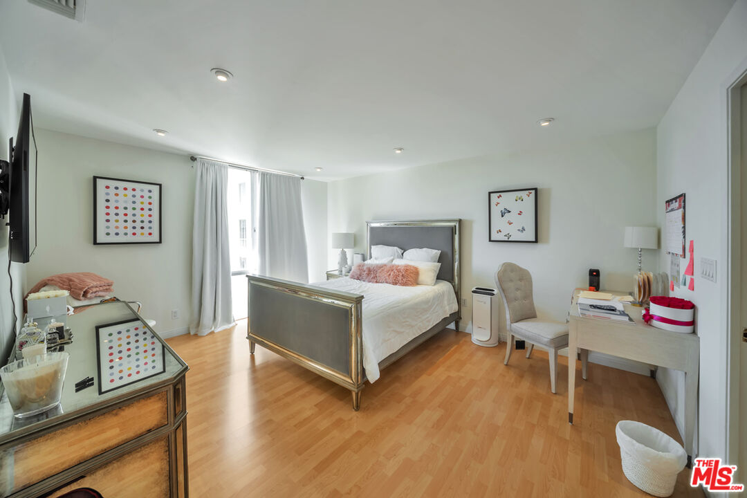 2170 Century Park East, Unit 1807 Los Angeles, CA 90067 - Photo 4 of 30 a bedroom with a bed and wooden floor