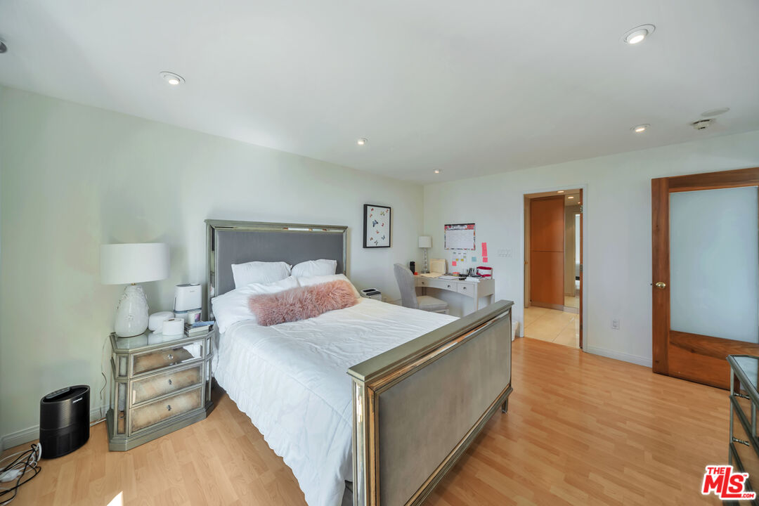 2170 Century Park East, Unit 1807 Los Angeles, CA 90067 - Photo 5 of 30 a bedroom with a bed and a lamp