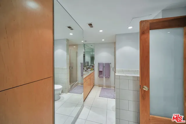 a bathroom with a glass shower door and a mirror