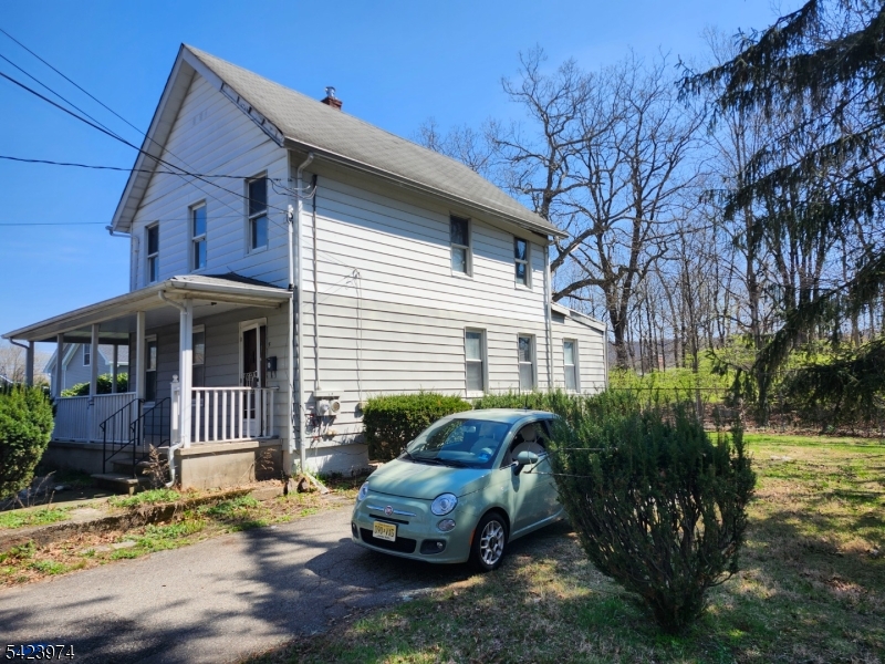 5 Locust Street Wanaque, NJ 07420 - Photo 4 of 23 a front view of a house with garden