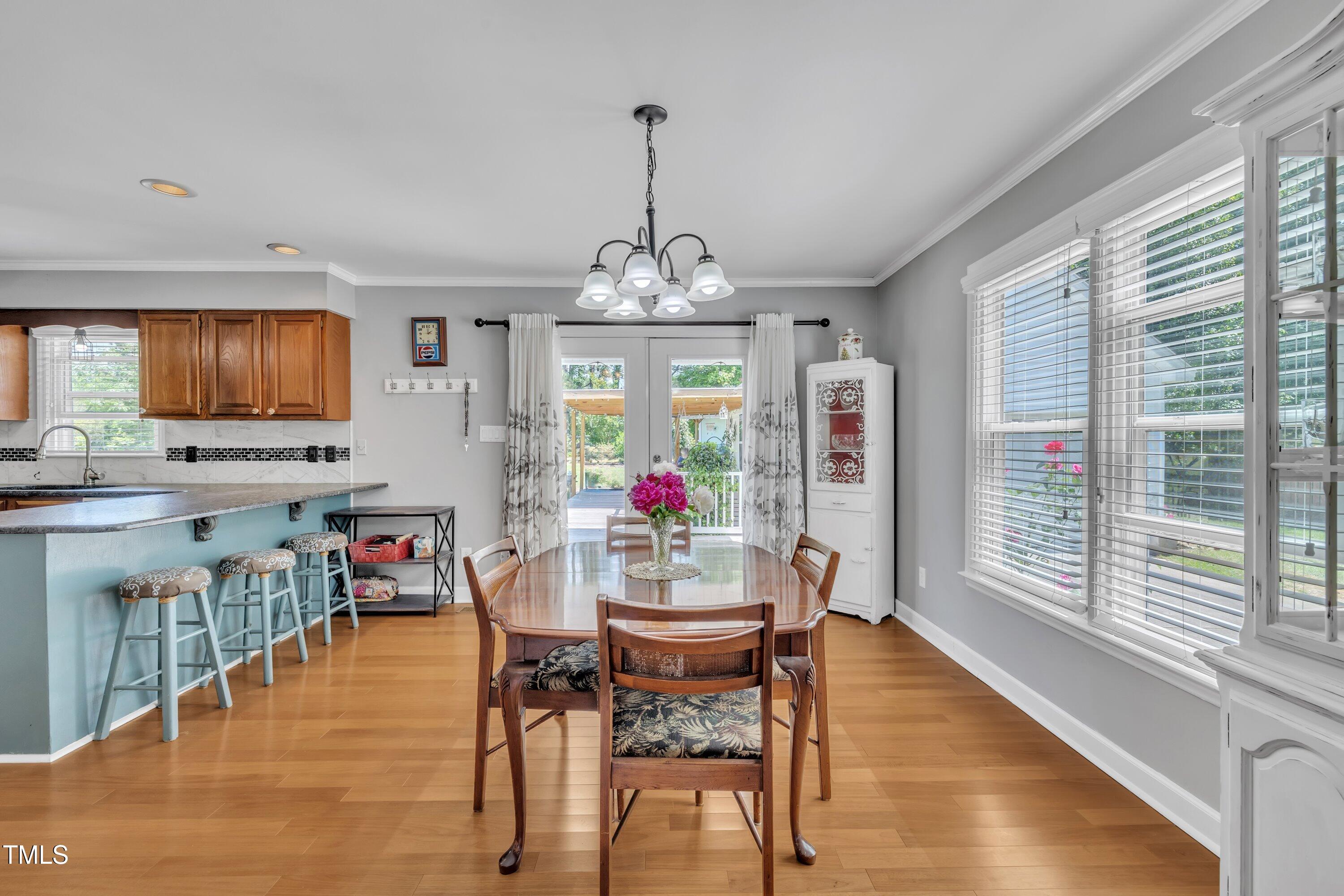 1112 Turner Farms Road Garner, NC 27529 - Photo 13 of 43 a view of a dining room with furniture window and wooden floor