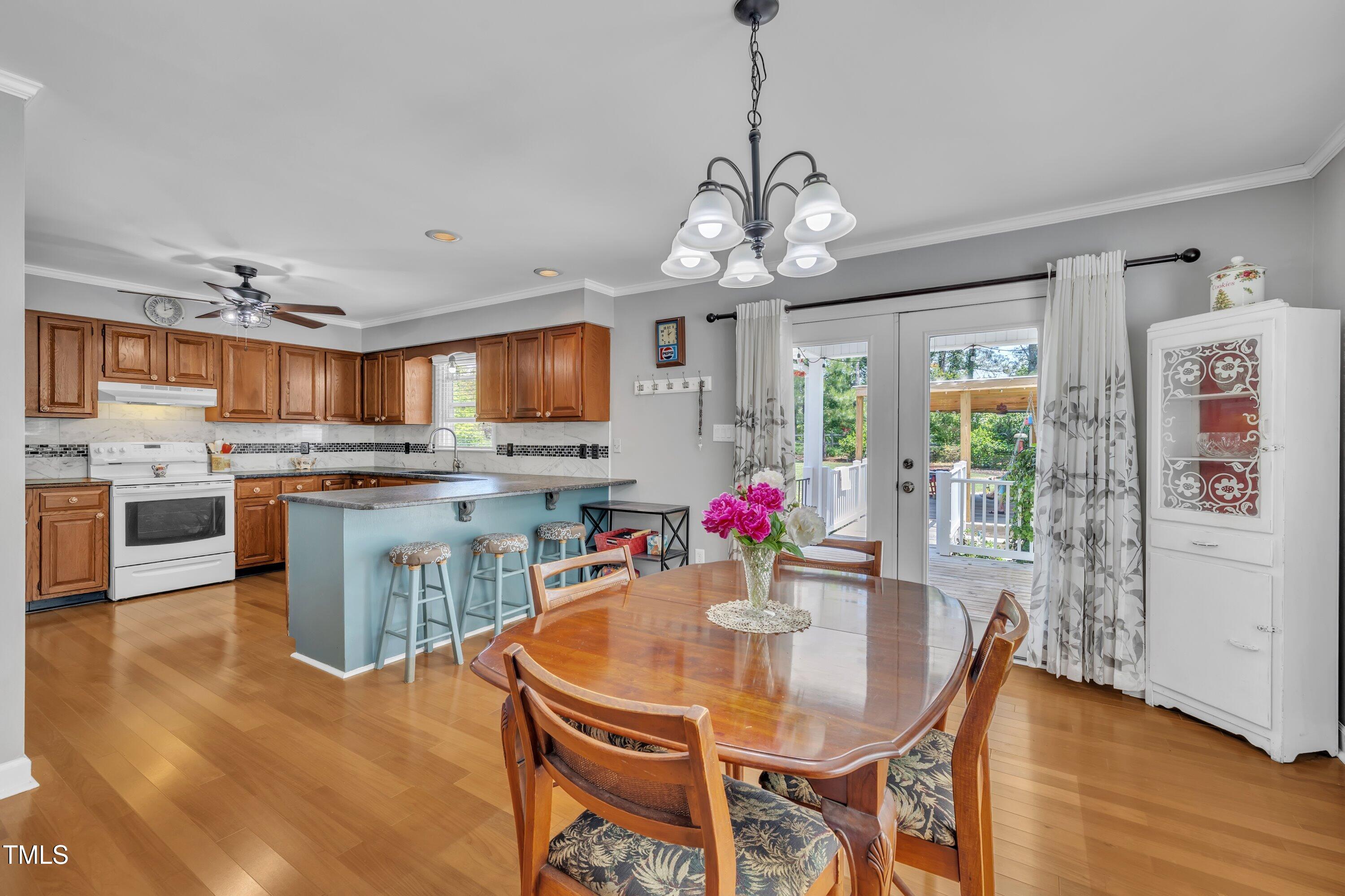 1112 Turner Farms Road Garner, NC 27529 - Photo 14 of 43 a view of a dining room and livingroom with furniture wooden floor a chandelier