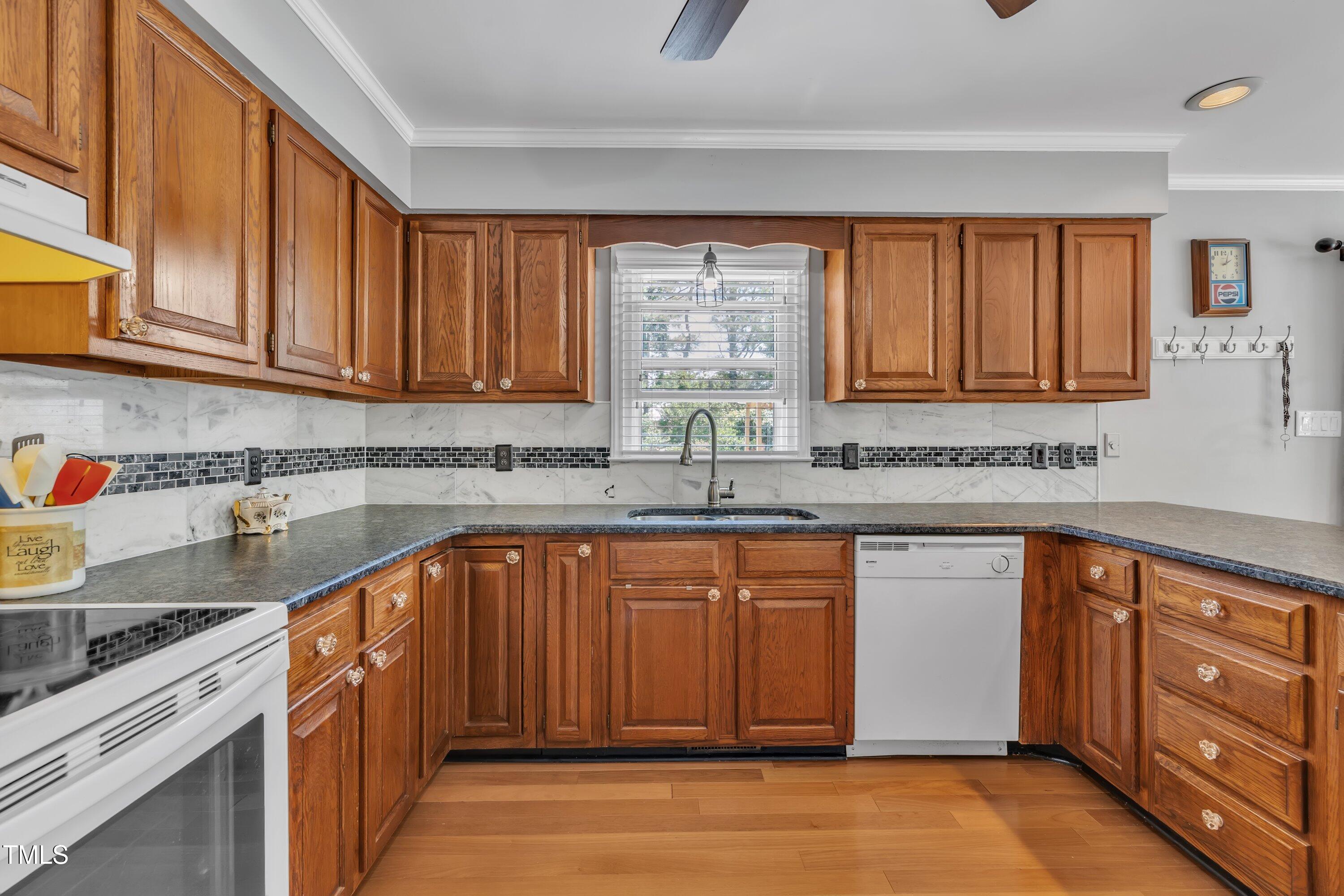 1112 Turner Farms Road Garner, NC 27529 - Photo 20 of 43 a kitchen with stainless steel appliances granite countertop a sink stove and cabinets