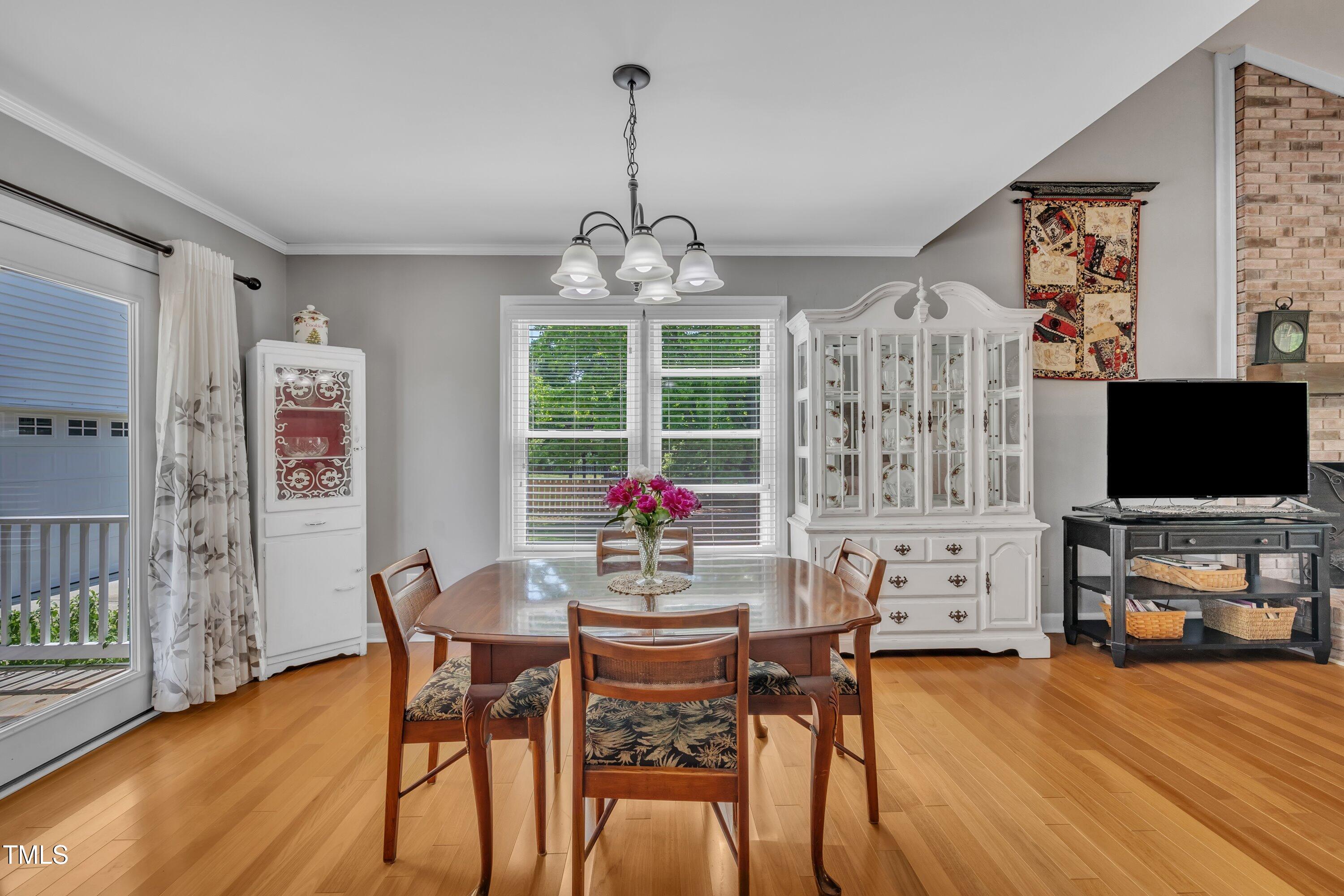 1112 Turner Farms Road Garner, NC 27529 - Photo 22 of 43 a view of a dining room with furniture window and wooden floor