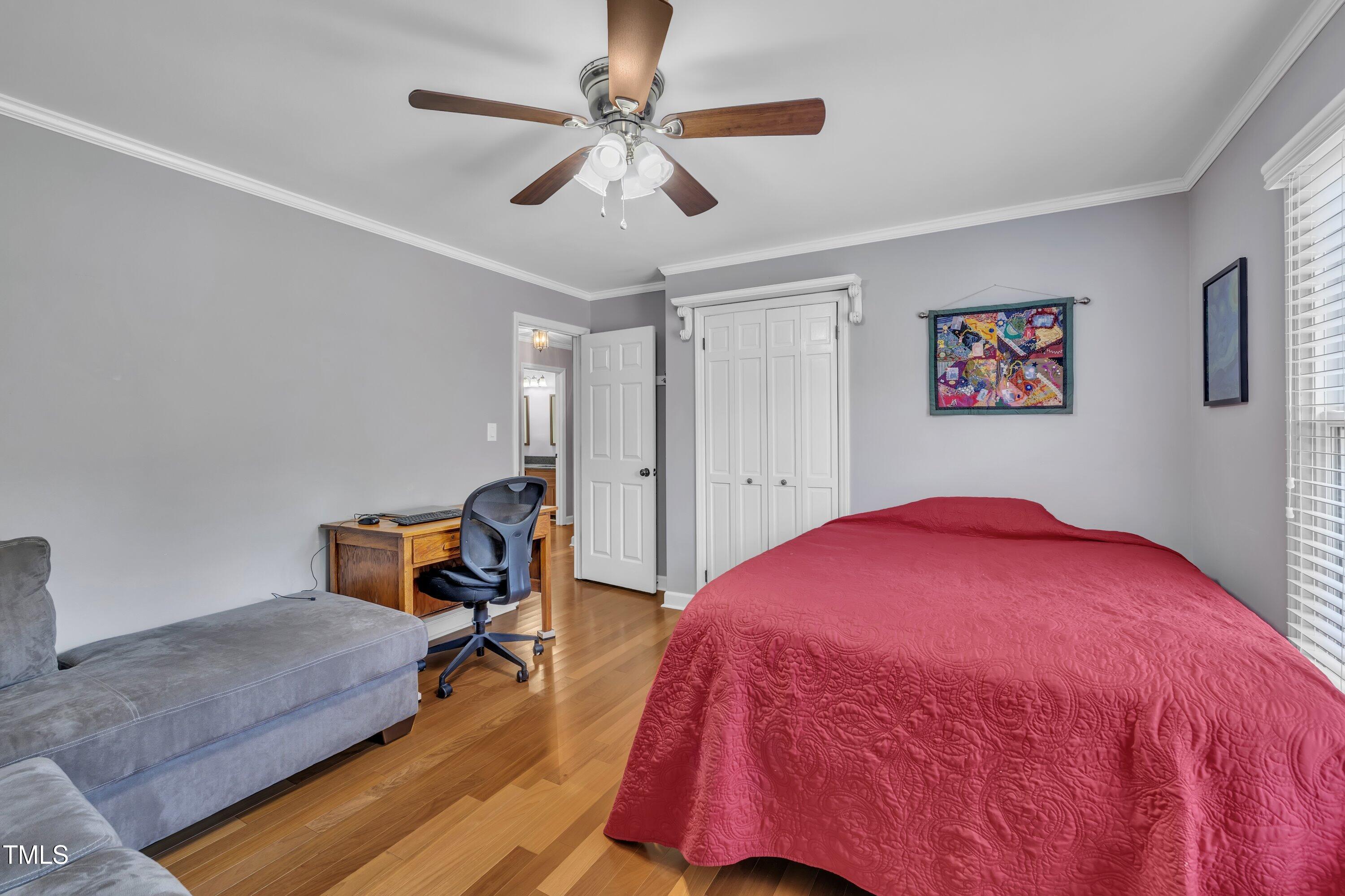 1112 Turner Farms Road Garner, NC 27529 - Photo 31 of 43 a bedroom with a bed and a chandelier