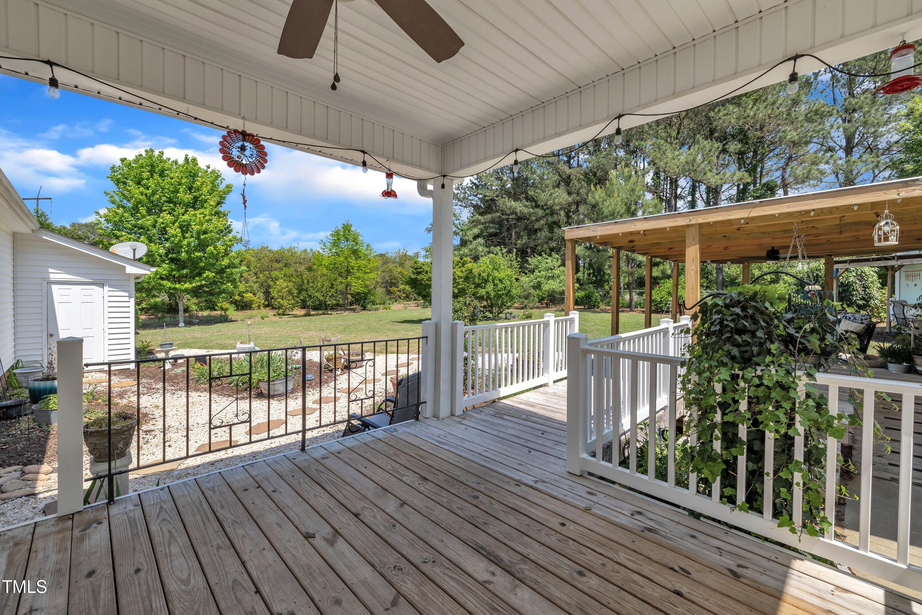 1112 Turner Farms Road Garner, NC 27529 - Photo 36 of 43 a view of a chairs and table on the wooden deck
