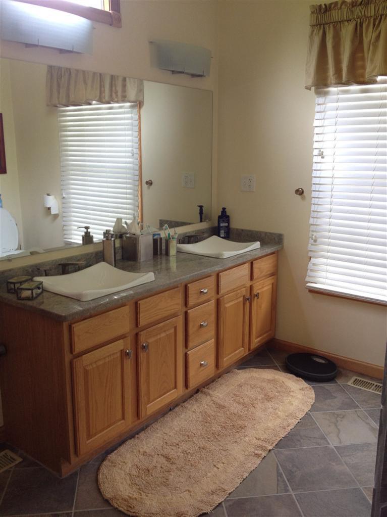 65 River Harbor Road Wellfleet, MA 02667 - Photo 17 of 35 a spacious bathroom with a granite countertop sink and a window