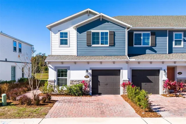 a front view of a house with a yard and a garage