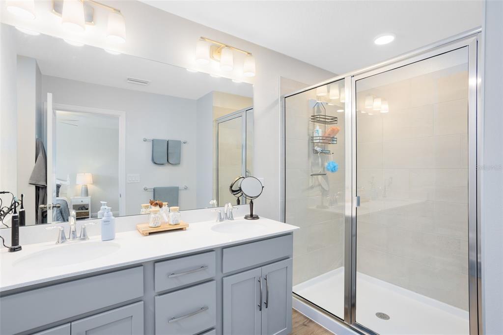 4394 Campsite Loop Orlando, FL 32824 - Photo 21 of 40 a bathroom with a shower sink and mirror