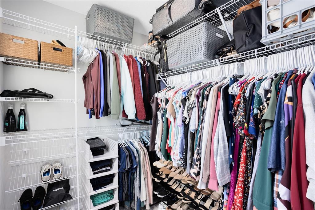 4394 Campsite Loop Orlando, FL 32824 - Photo 22 of 40 a view of walk in closet with clothes and shoes
