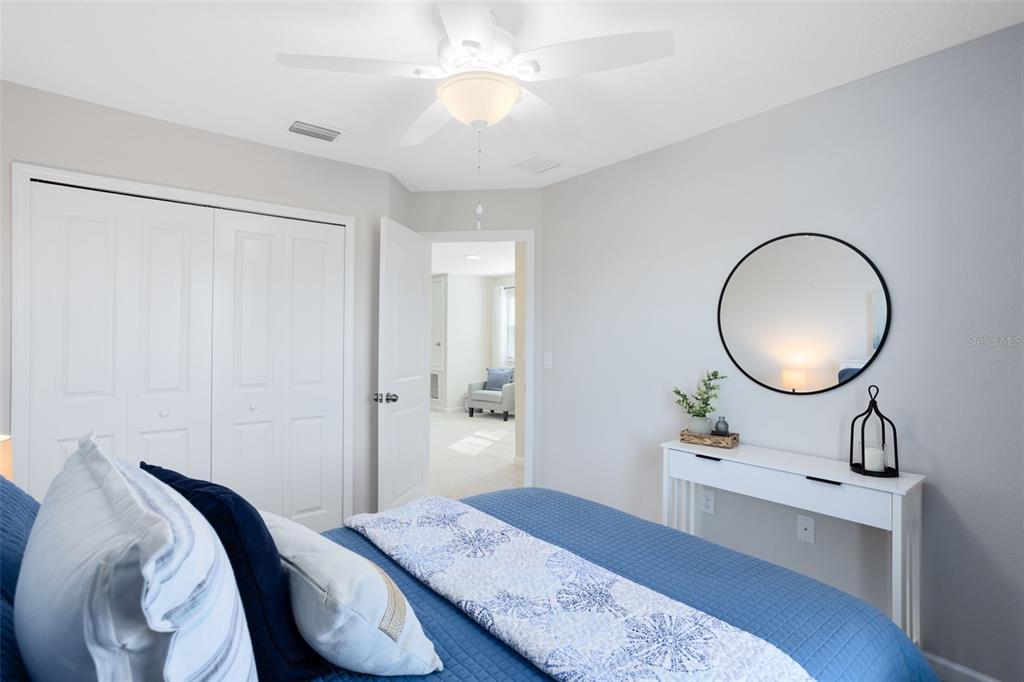 4394 Campsite Loop Orlando, FL 32824 - Photo 25 of 40 a bedroom with a bed and a chandelier