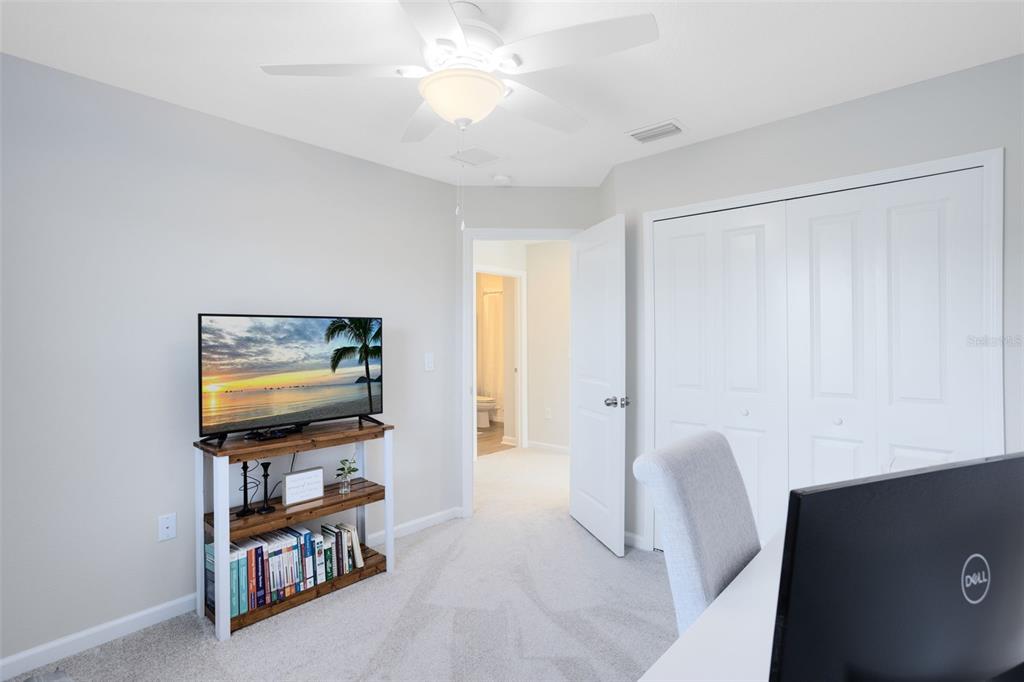 4394 Campsite Loop Orlando, FL 32824 - Photo 26 of 40 a living room with furniture and a flat screen tv