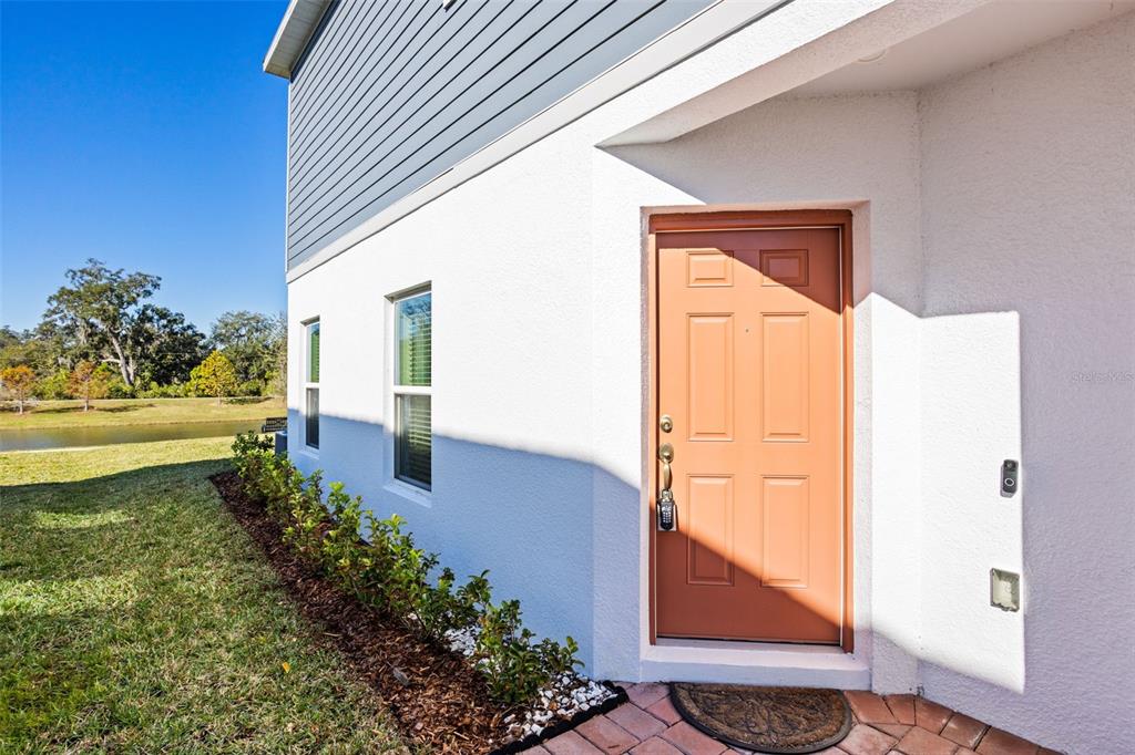 4394 Campsite Loop Orlando, FL 32824 - Photo 3 of 40 a view of a hallway with wooden floor and a dining table