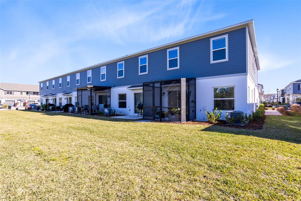 4394 Campsite Loop Orlando, FL 32824 - Photo 32 of 40 a front view of a building with a garden