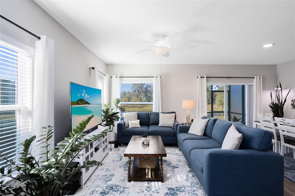 4394 Campsite Loop Orlando, FL 32824 - Photo 5 of 40 a living room with furniture flat screen tv and a large window