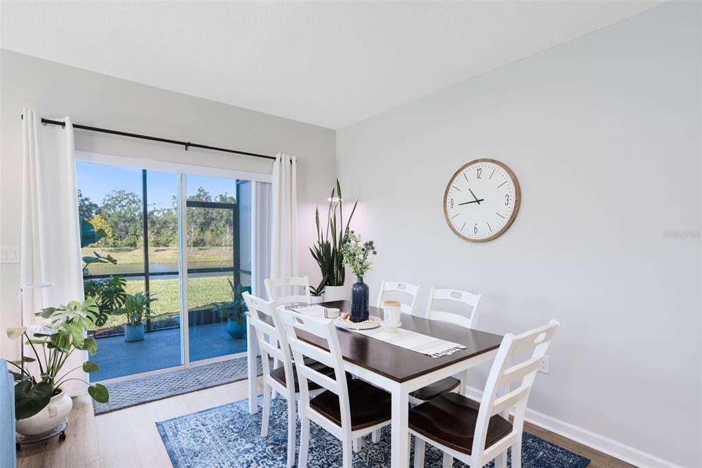 4394 Campsite Loop Orlando, FL 32824 - Photo 7 of 40 a dining room with furniture potted plants and wooden floor