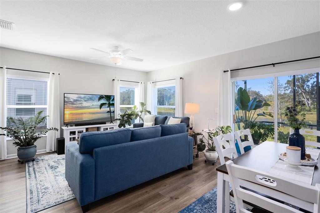 4394 Campsite Loop Orlando, FL 32824 - Photo 9 of 40 a living room with furniture flat screen tv and a large window