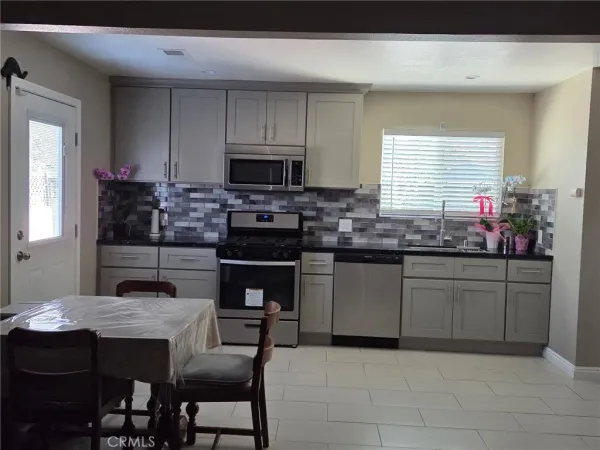 a kitchen with stainless steel appliances kitchen island granite countertop a sink and cabinets