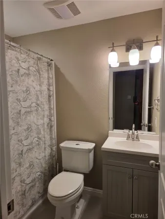 a bathroom with a toilet a sink and a mirror