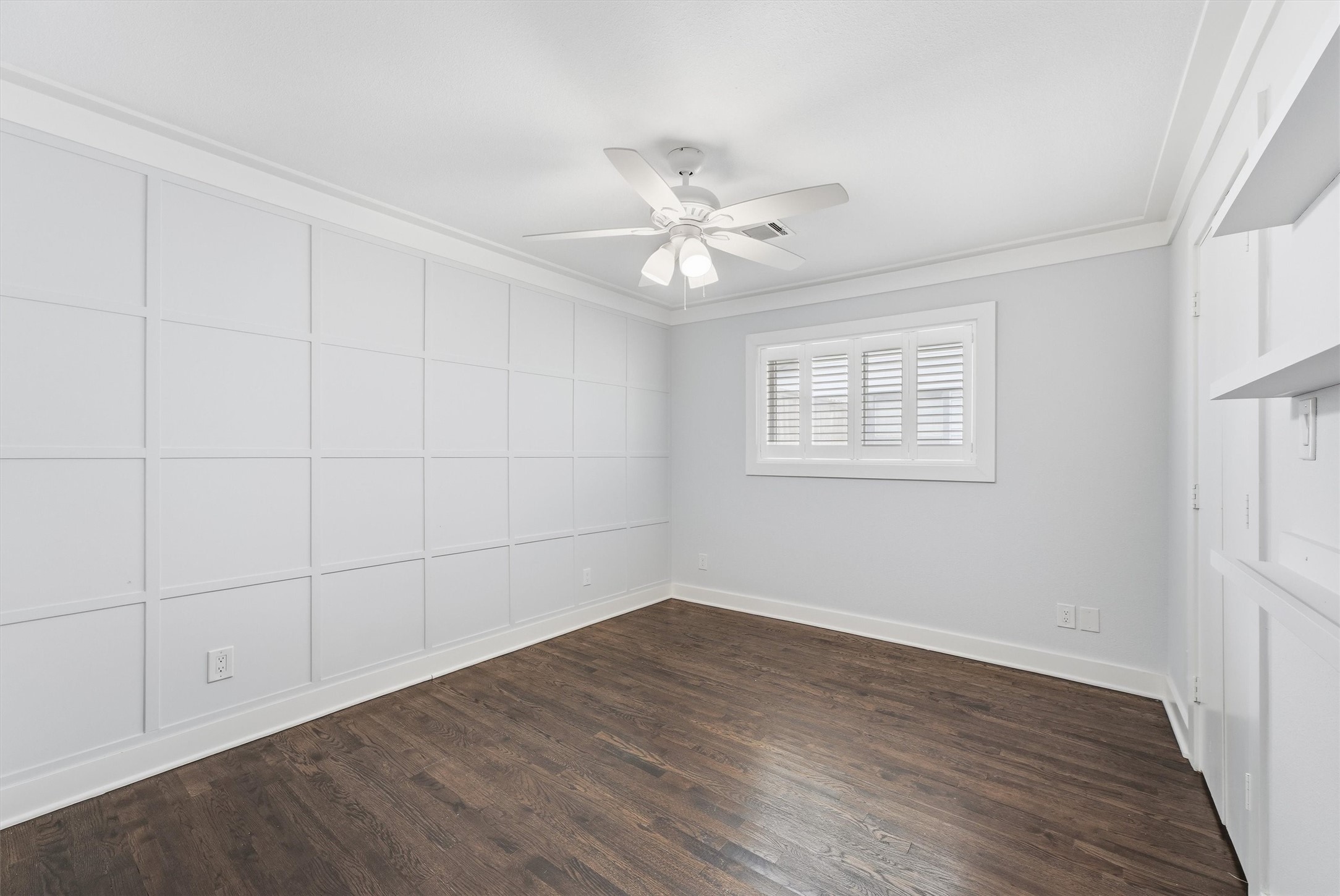 4701 Hummingbird Street Houston, TX 77035 - Photo 18 of 28 One of the secondary bedrooms, featuring a stately paneled wall detail.