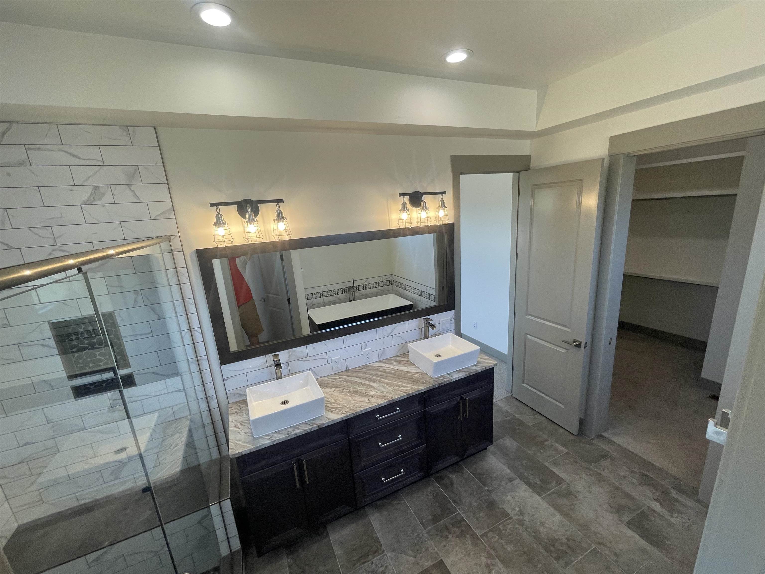 1697 P Road Loma, CO 81524 - Photo 13 of 39 a bathroom with a double vanity sink and mirror