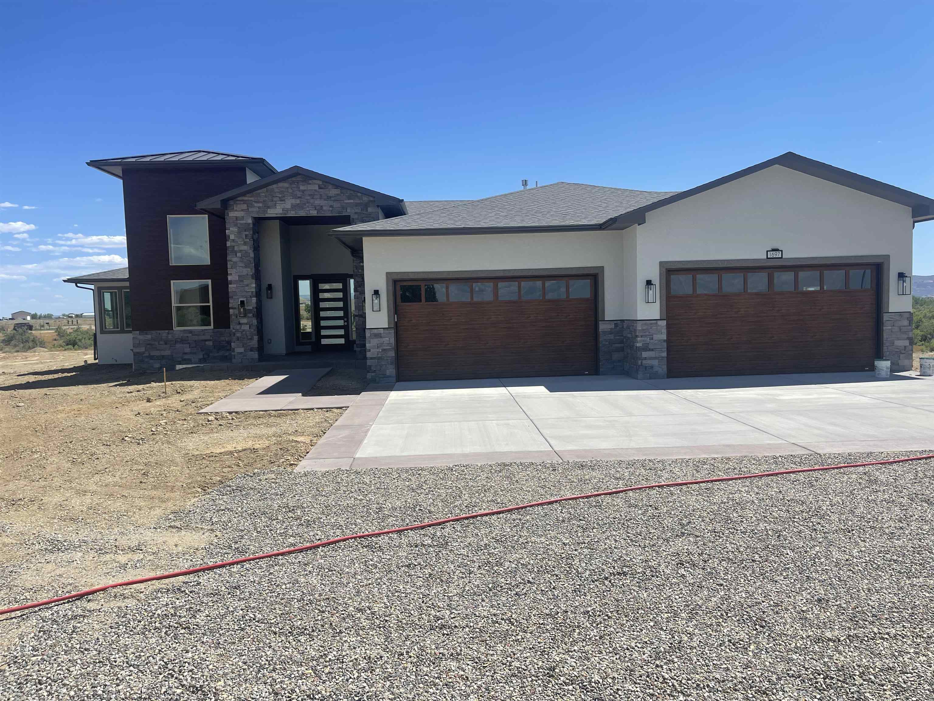 1697 P Road Loma, CO 81524 - Photo 32 of 39 a front view of a house with a yard and garage